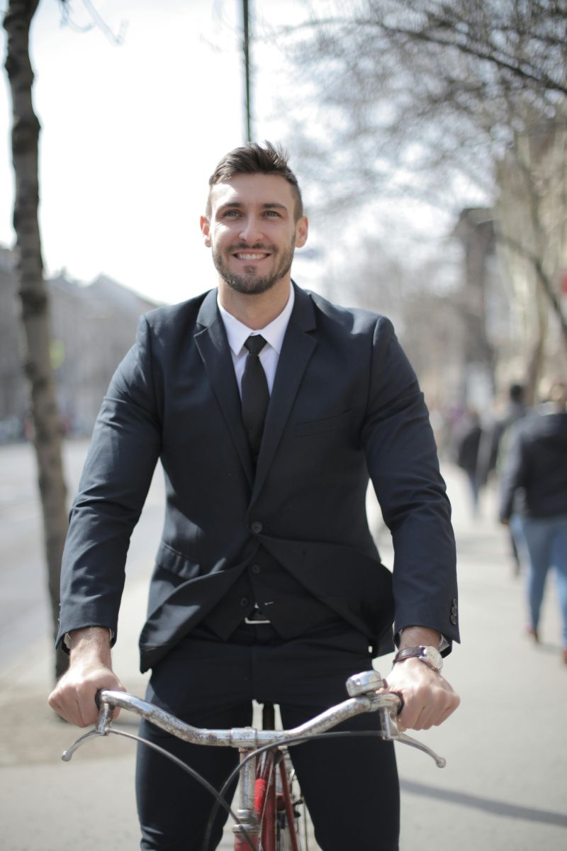 man in pak op fiets